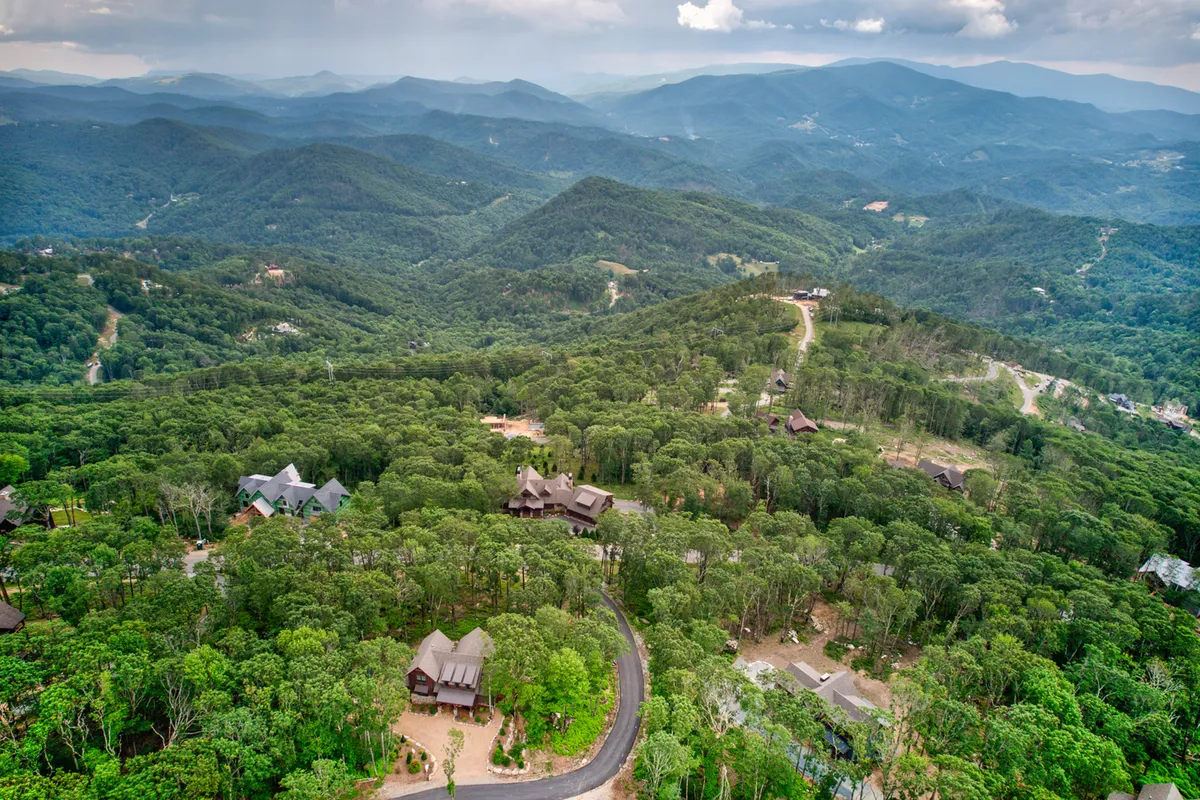 A panoramic view of the mountainous landscape, dense forests, and scattered homes in the Eagles Nest community. The scenery captures both the sense of adventure available for guests and the natural beauty pets and owners can explore together.